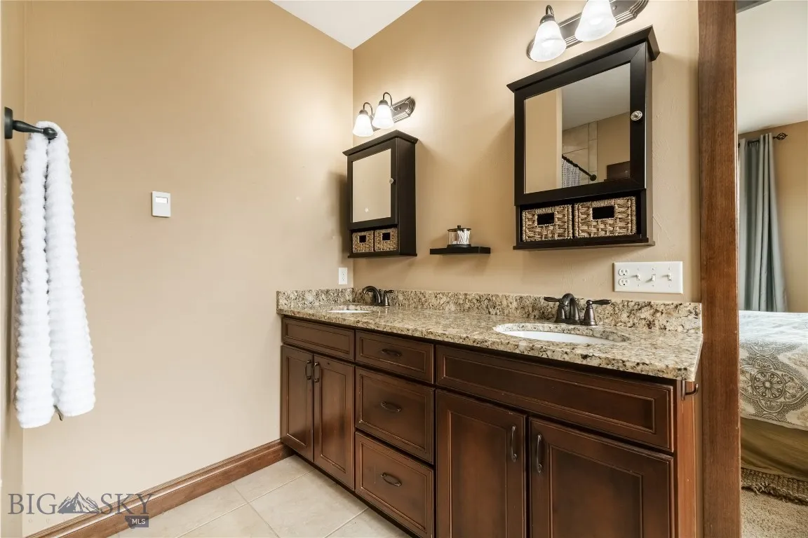 Main floor master with wood cabinetry and granite countertop