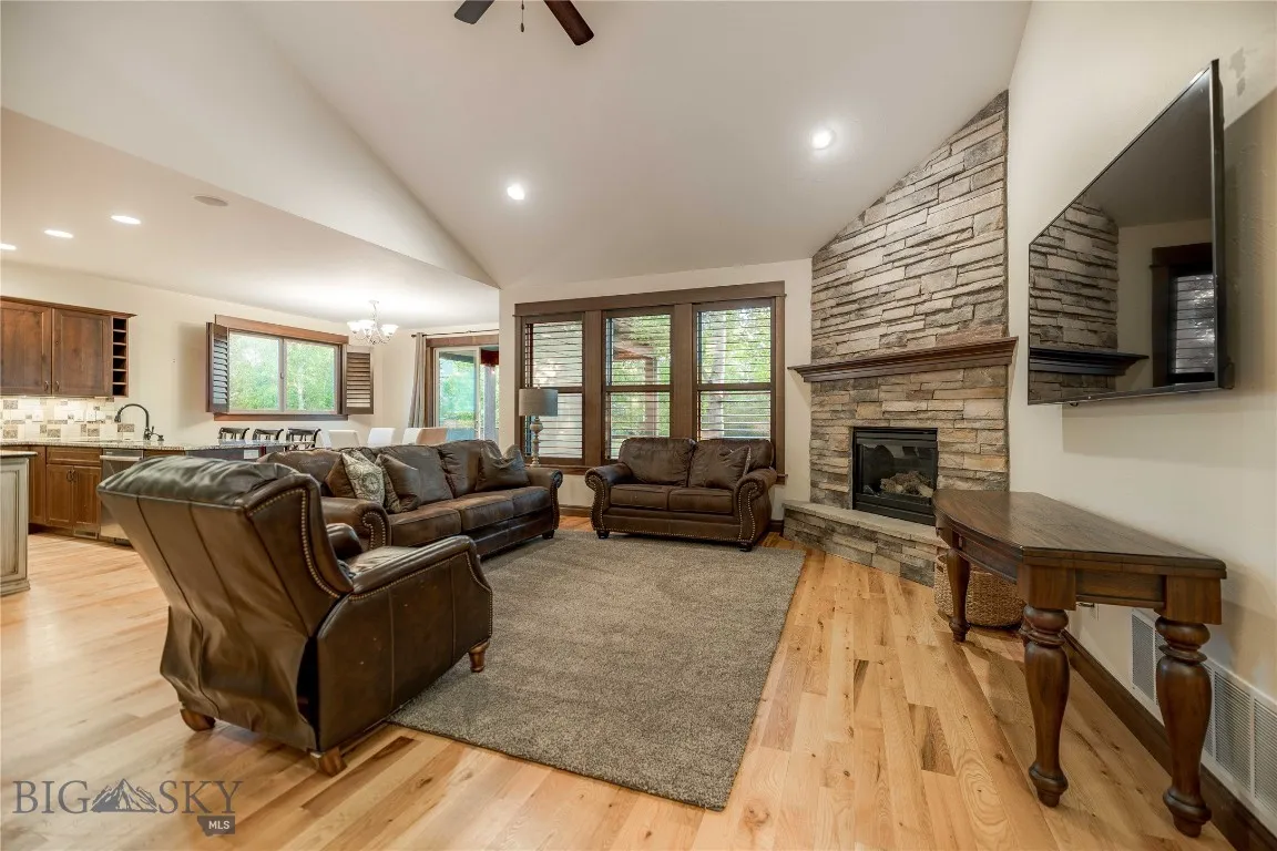 Living area with stacked stone gas fireplace