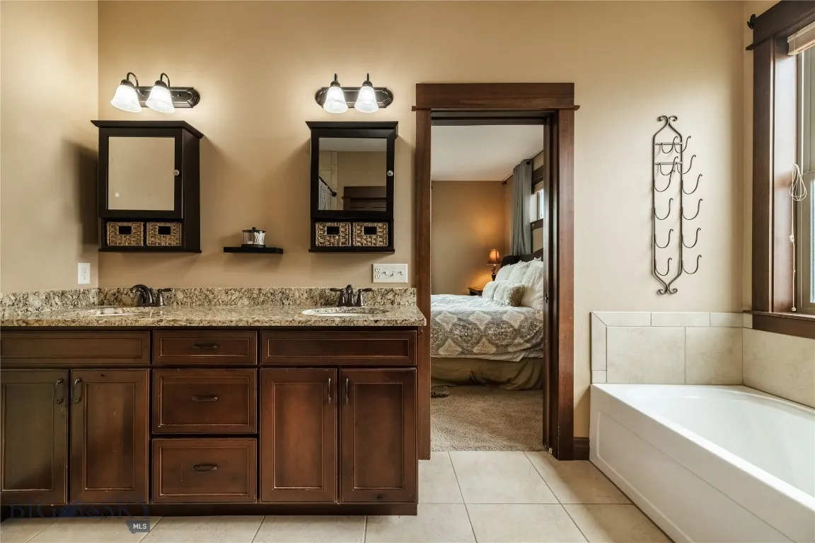 Main floor master bath with dual vanity & soaking tub.