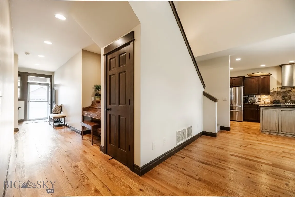 Front hall nook and closet opening up to living area and kitchen.