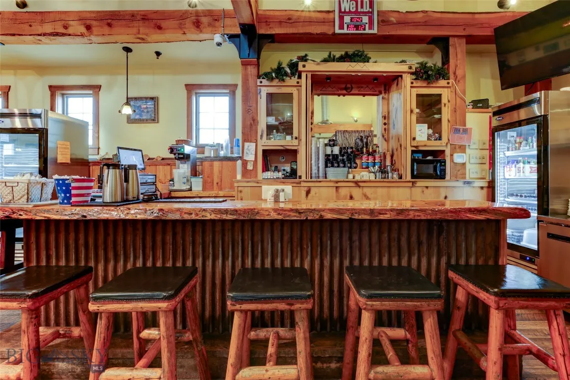 Restaurant Side Bar featuring stainless steel fridge and pendant lighting