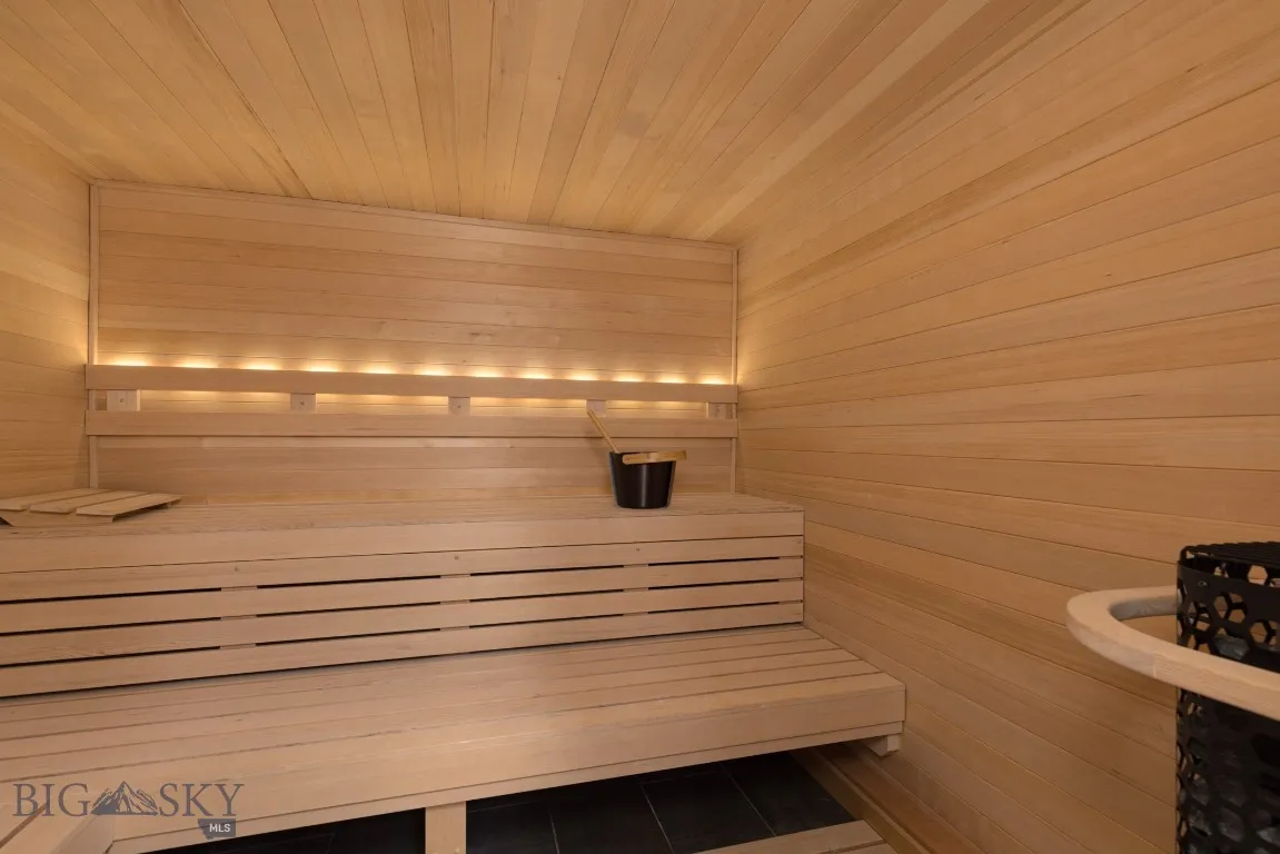 View of sauna featuring wooden ceiling and wooden walls