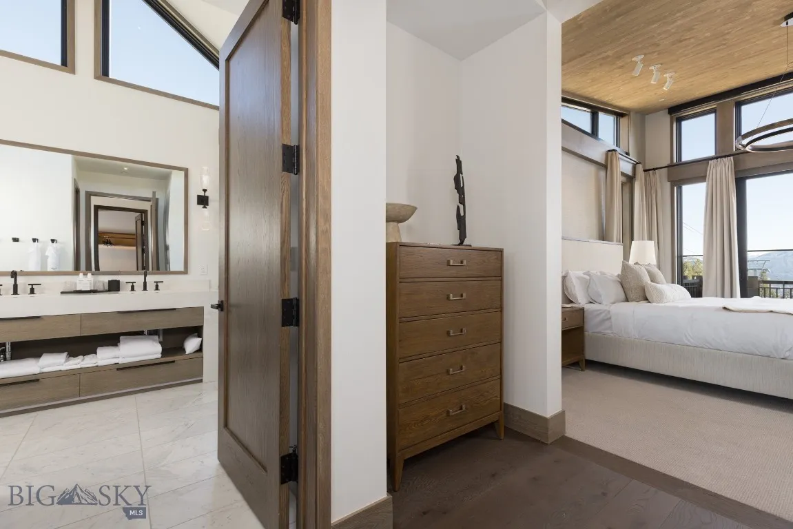 Bedroom featuring sink, high vaulted ceiling, light hardwood / wood-style flooring, and wood ceiling