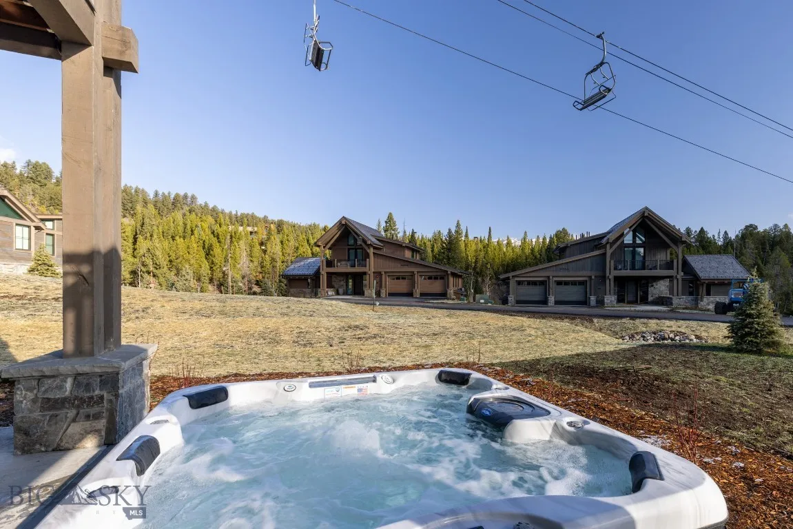 View of yard with a hot tub and a garage