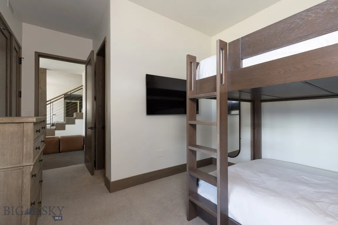 Bedroom featuring light colored carpet