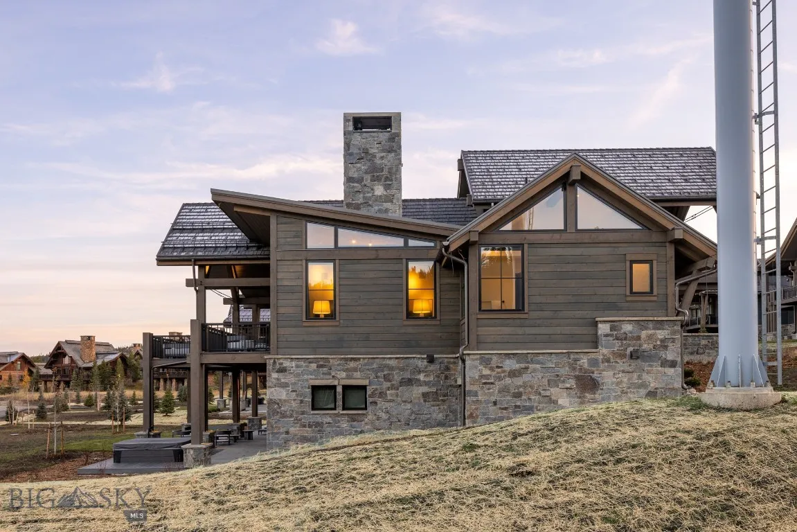 Back house at dusk with a patio area and a balcony