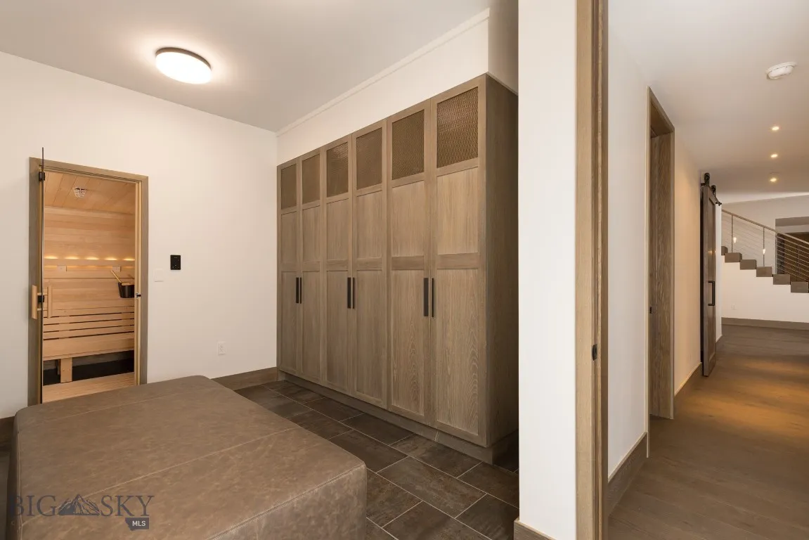 Hallway featuring a barn door and dark wood-type flooring