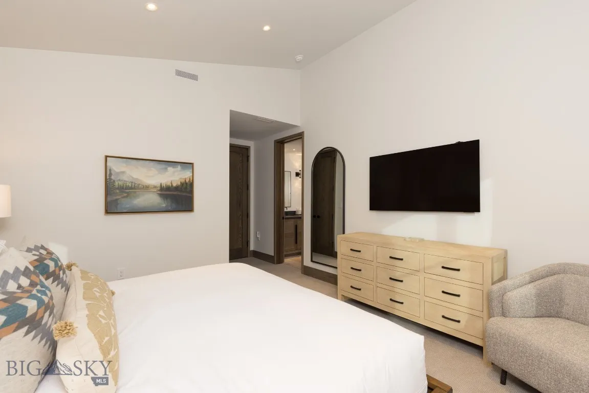 Carpeted bedroom featuring lofted ceiling