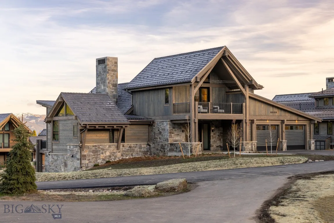 View of front of house with a balcony and a garage