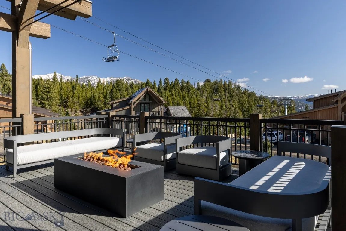 Deck with a mountain view and an outdoor fire pit