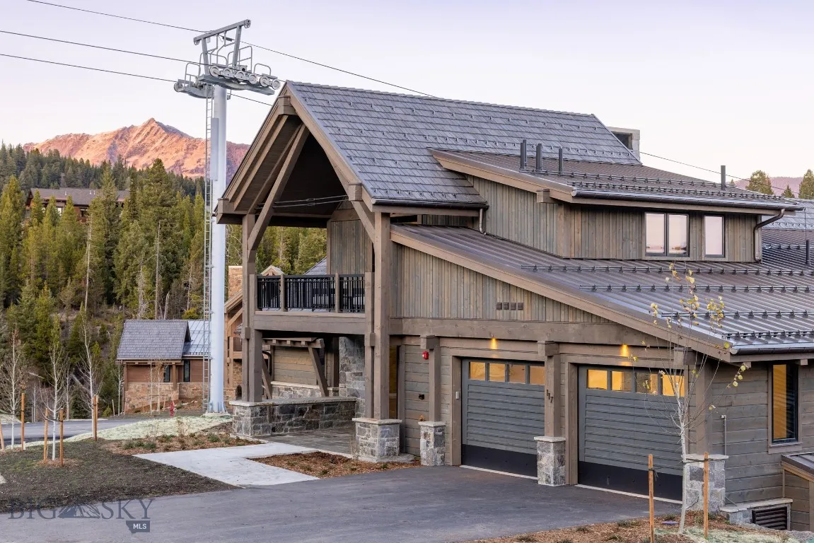 View of front of house with a mountain view, a balcony, and a garage