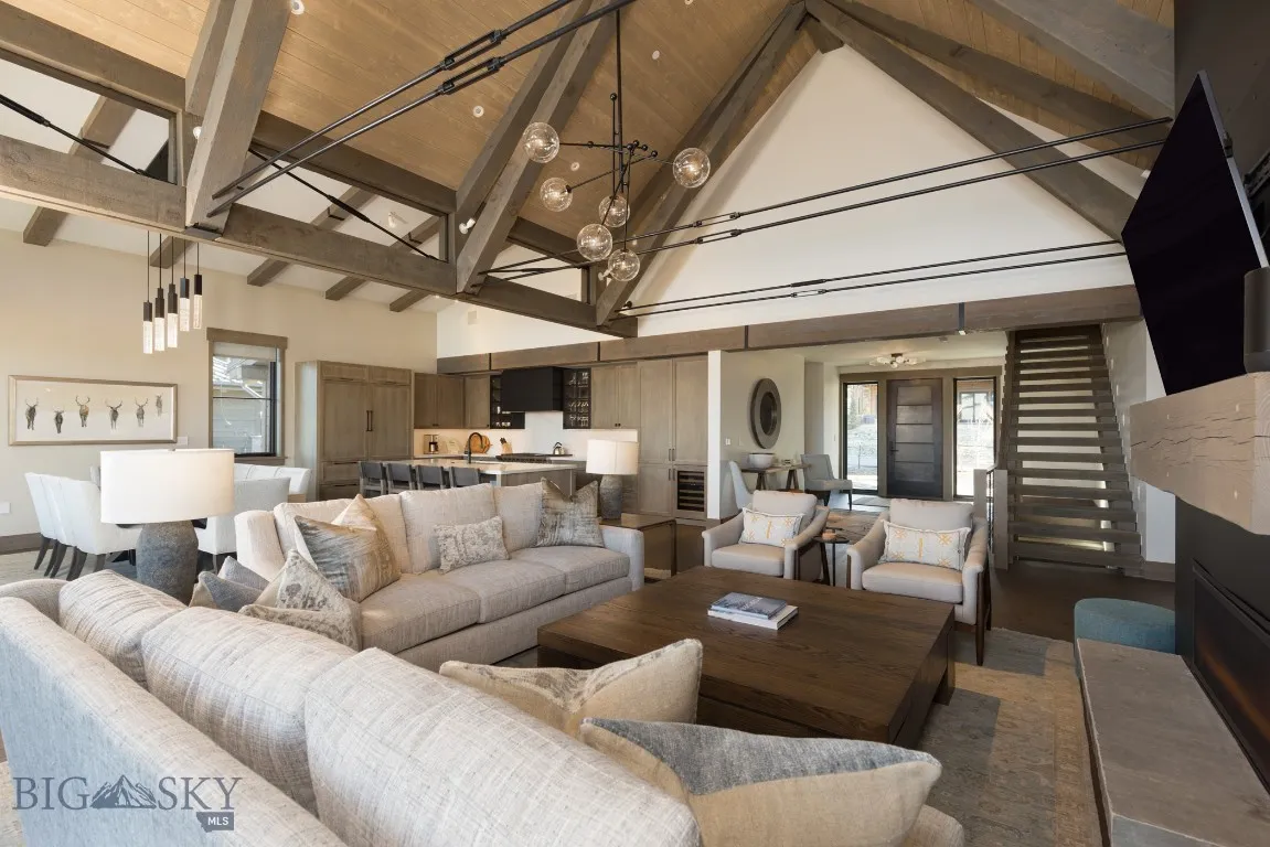 Living room featuring beamed ceiling, high vaulted ceiling, and wooden ceiling
