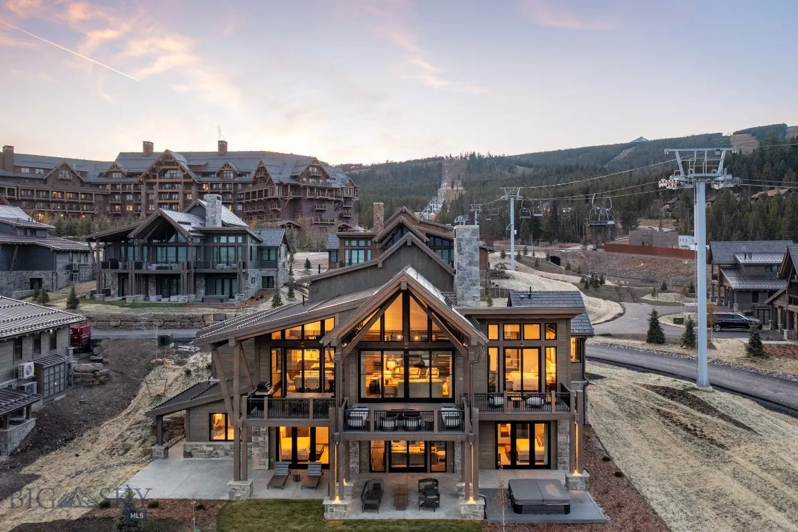 Back house at dusk with a balcony and a patio area
