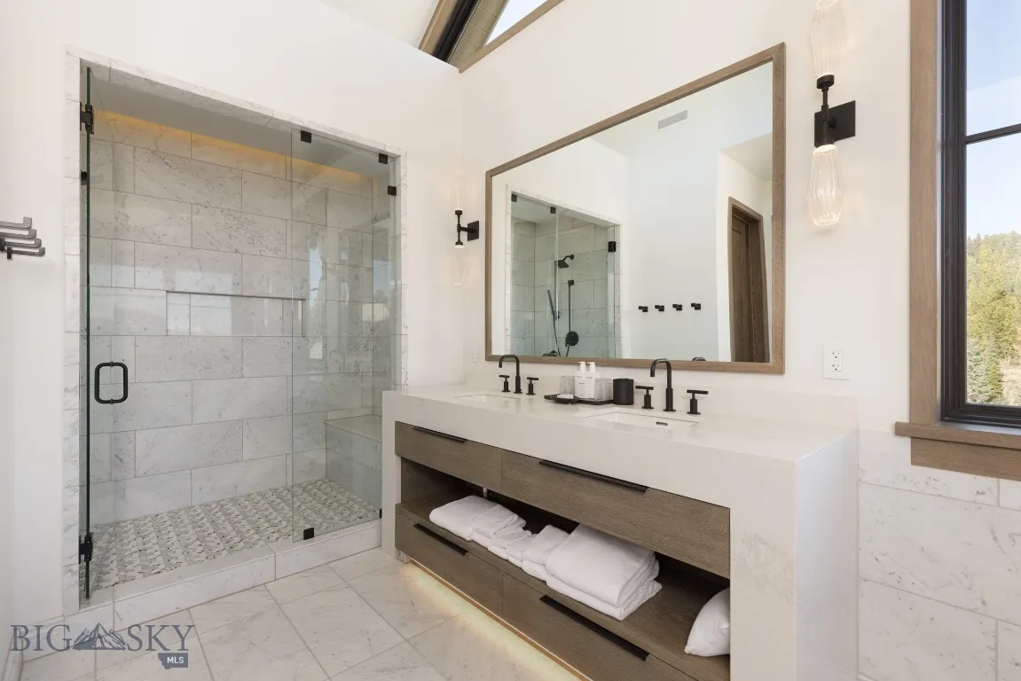 Bathroom with vanity and a shower with shower door