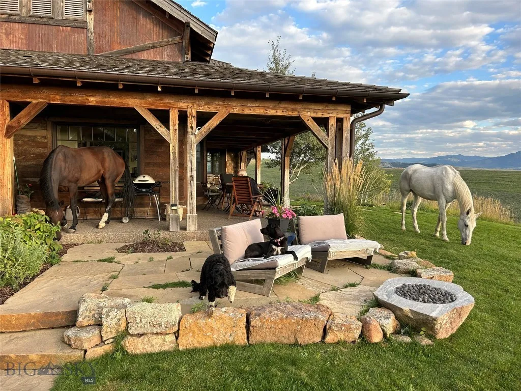 View of patio with a mountain view and an outdoor fire pit