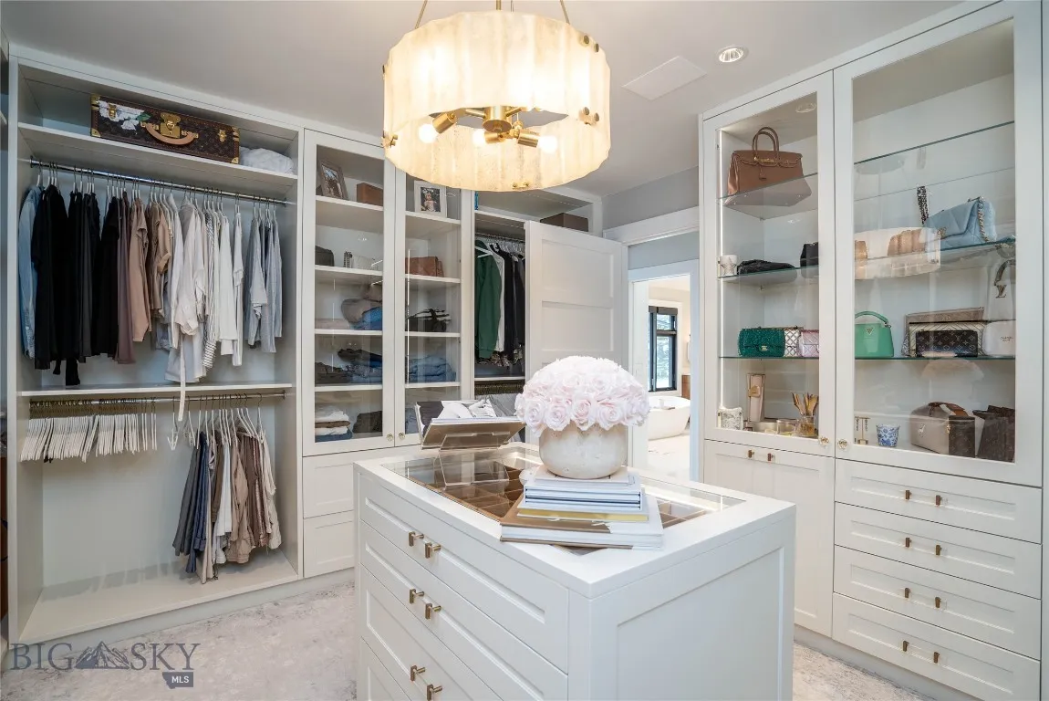 Dual Walk-in Closets with custom built-ins