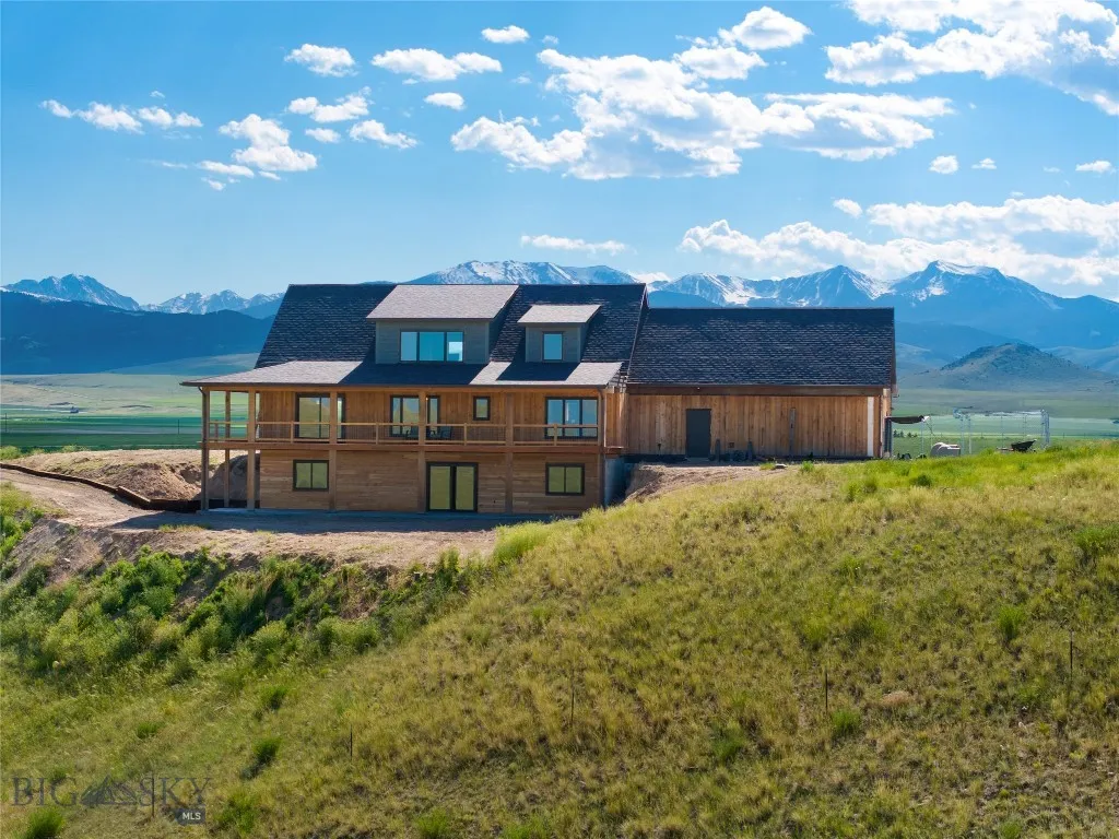 The back of the house, facing east, on the edge of the bench bordering State land