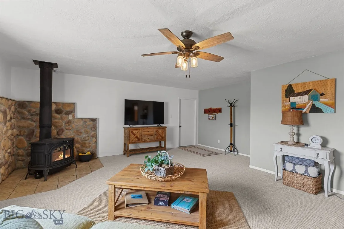 Expansive living room has both fireplace and baseboard heat