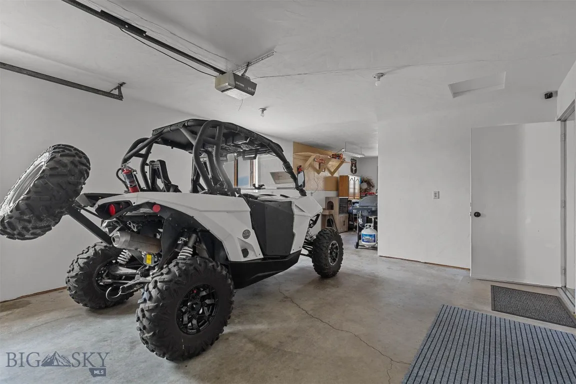 Garage features space for work shop.  Large enough to park motorcycle or fourwheeler in addition to a vehicle.