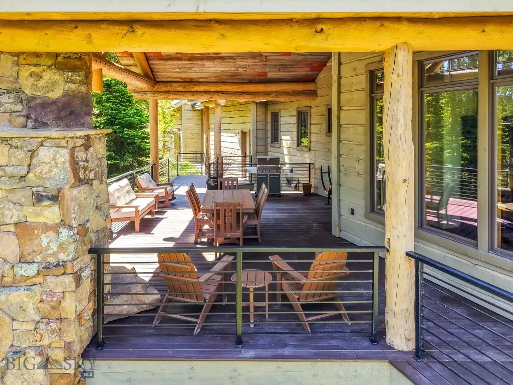 Covered deck with wood burning fireplace for outdoor entertaining