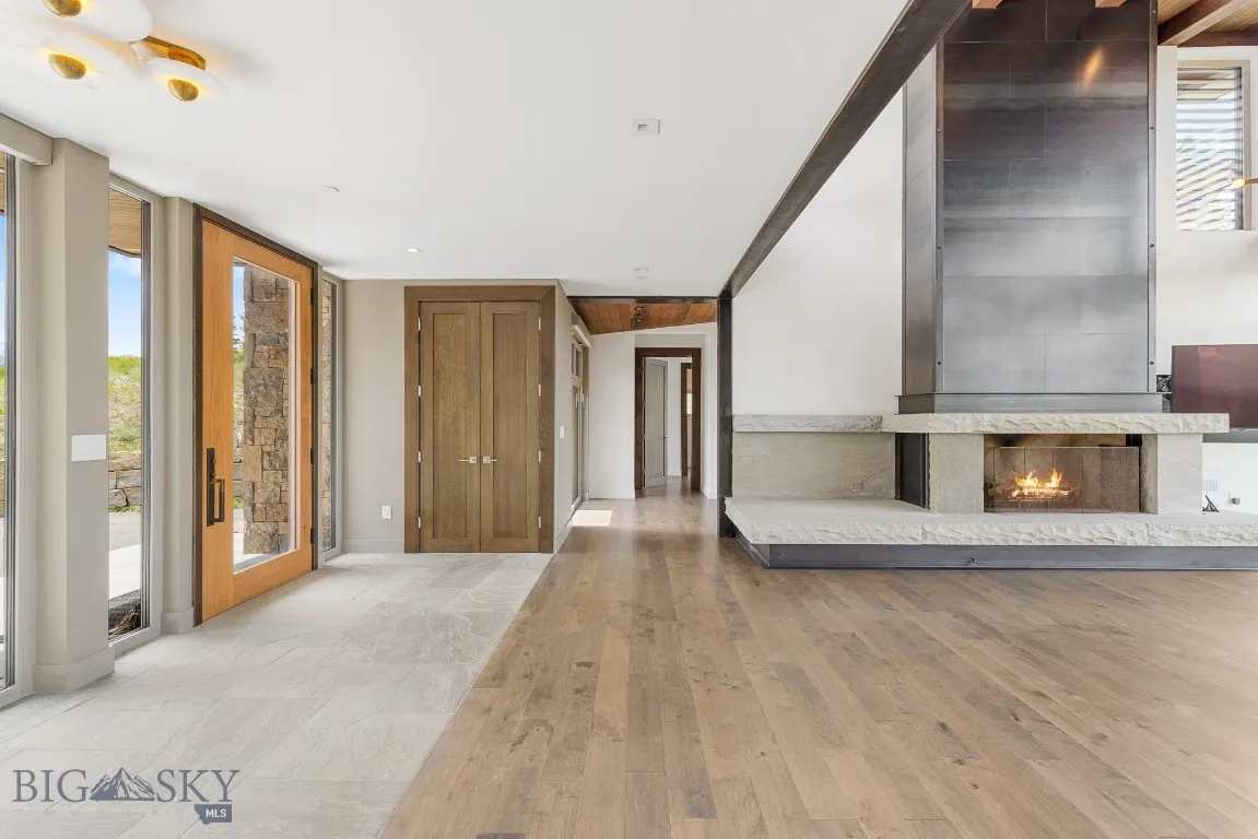 Primary Bedroom access is to the left of the fireplace. Main floor and private.