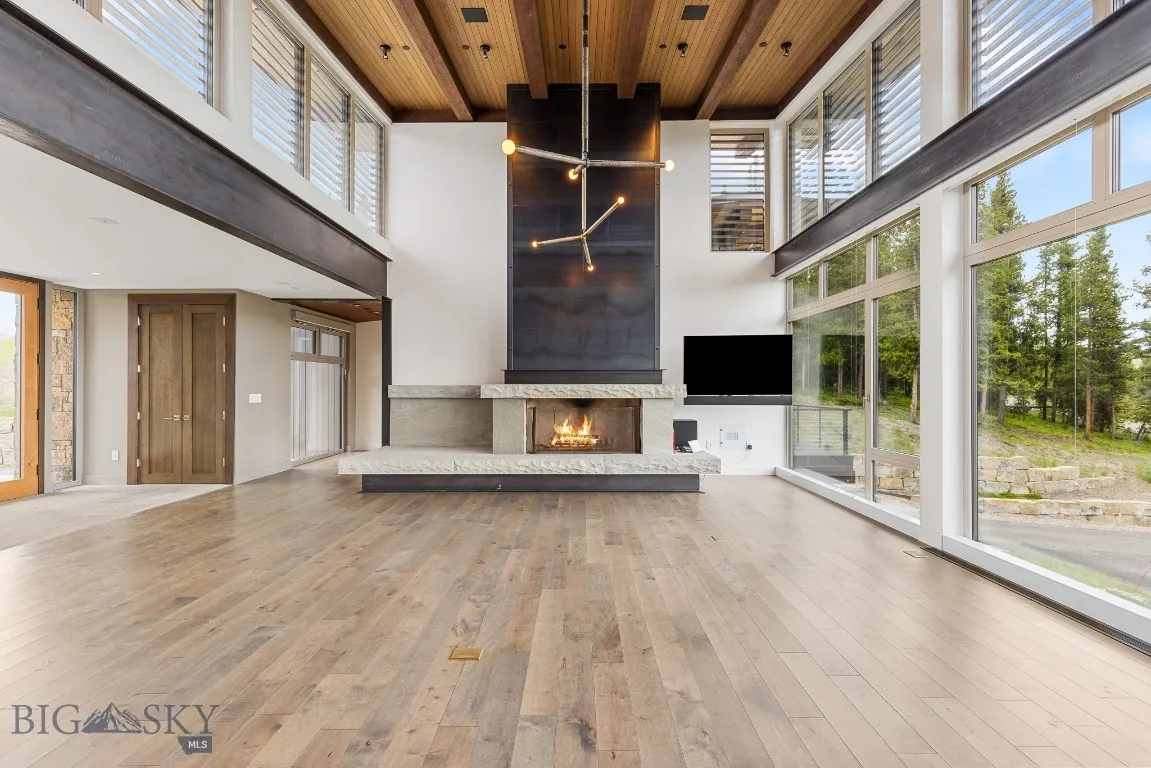 Living area boasts a beautiful gas custom fireplace of stone and steel.
