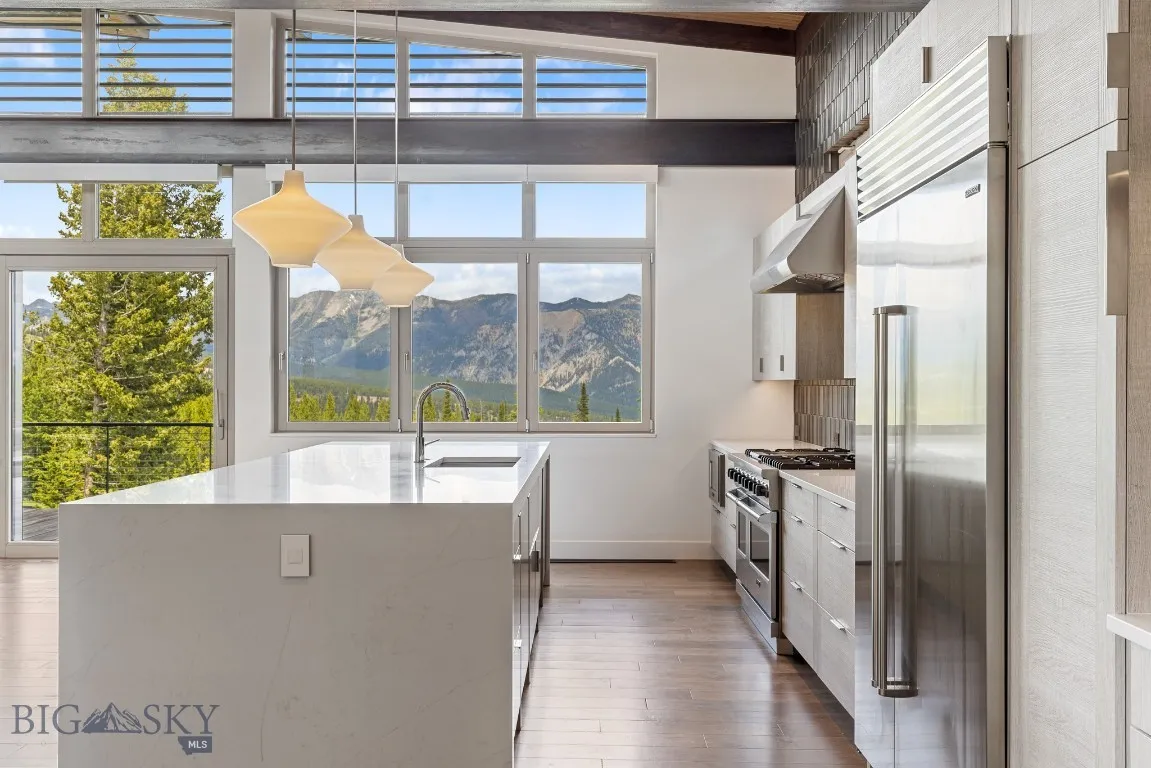 Kitchen detail with a subzero refrigerator, viking range, viking microwave and 2 Bosch dishwashers