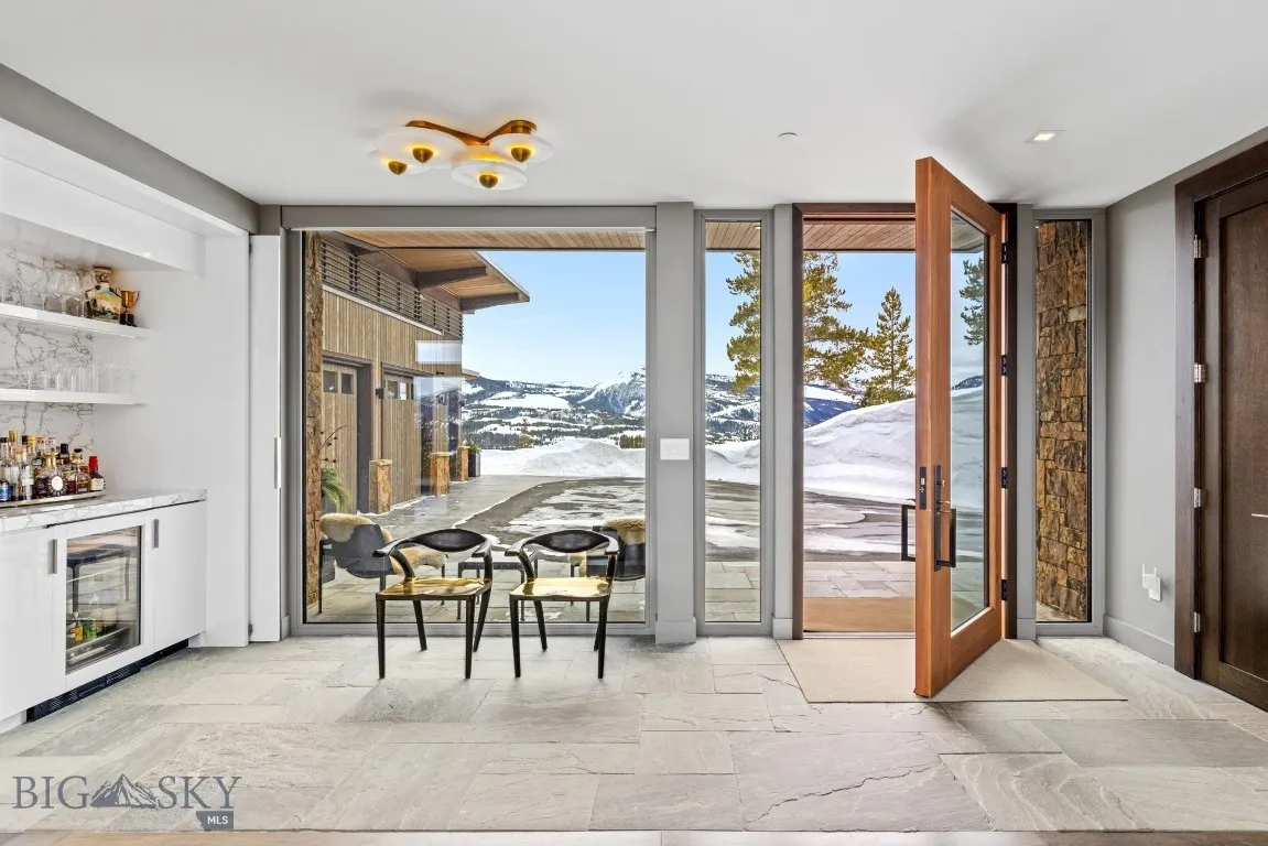 Main entry foyer with a custom designed wet bar ( previously furnished )