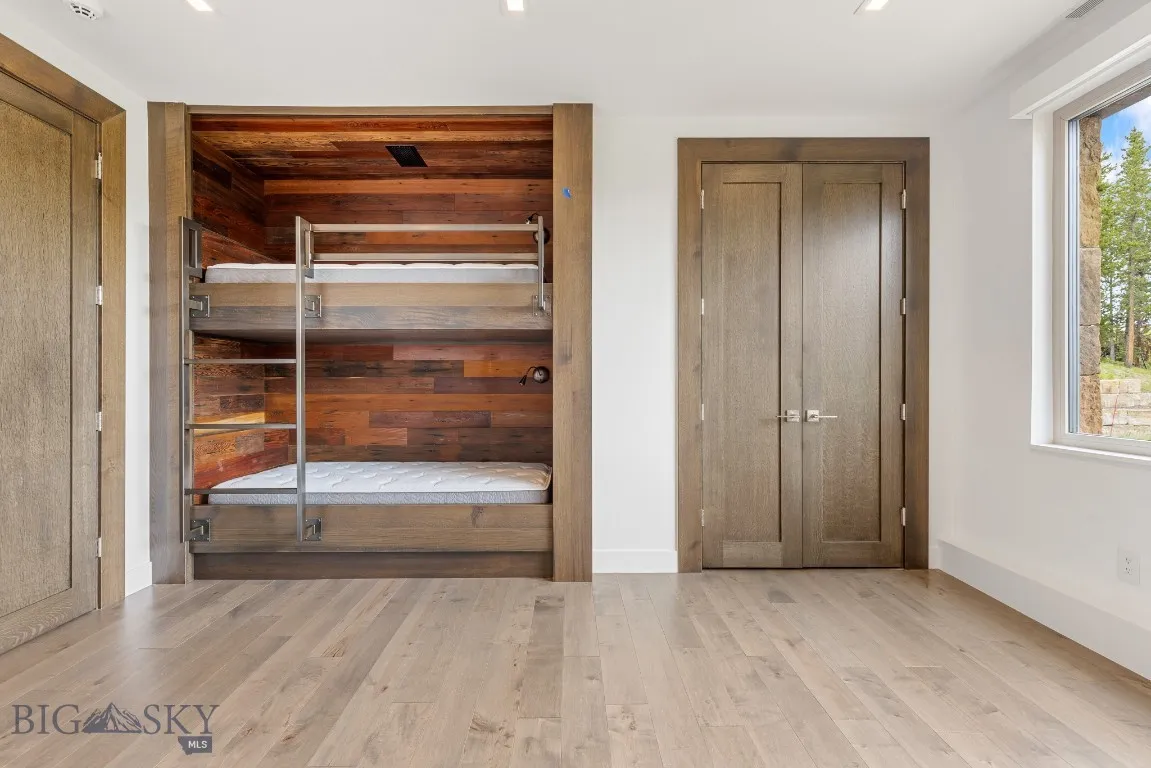 Bunks with reclaimed redwood accent wall. This room will also accommodate a queen bed