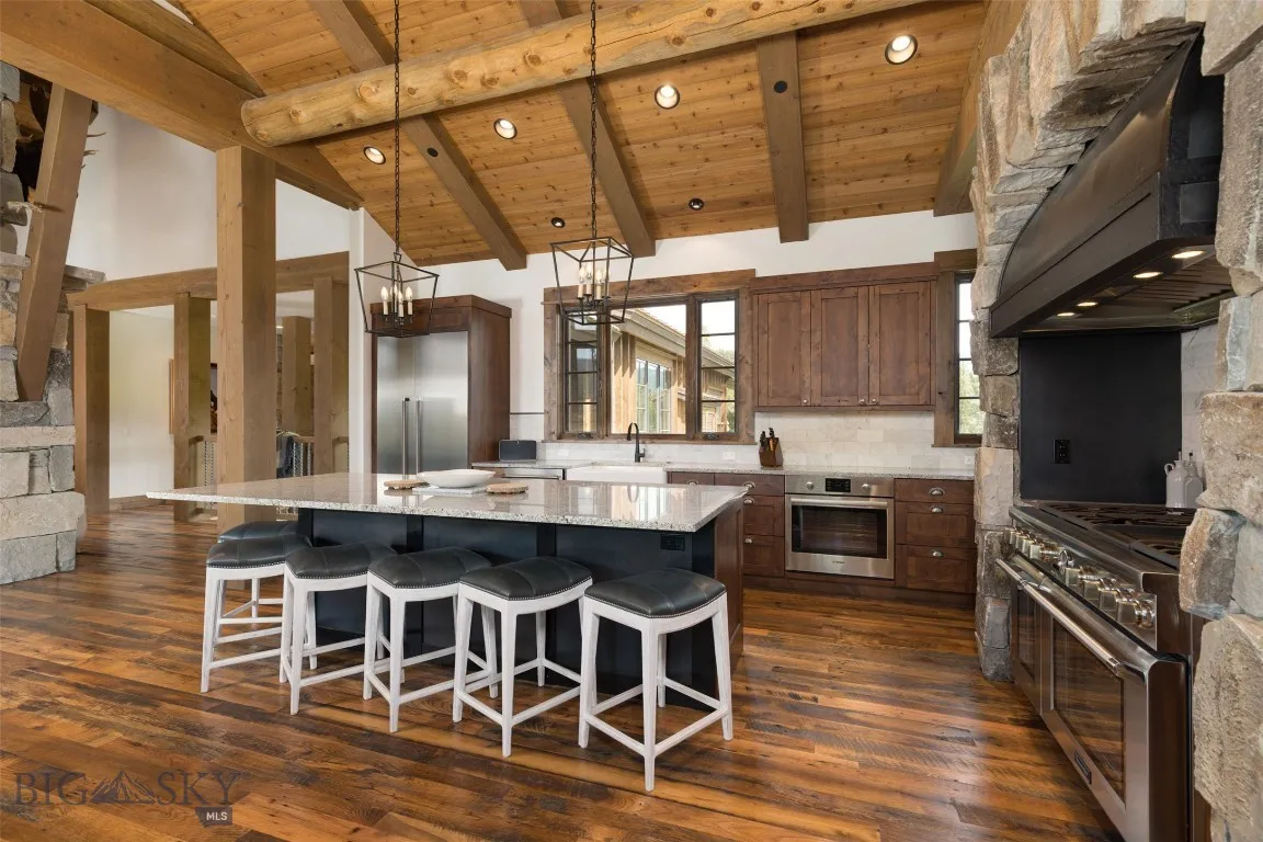 Gourmet kitchen featuring rich wood cabinetry, high-end stainless steel appliances