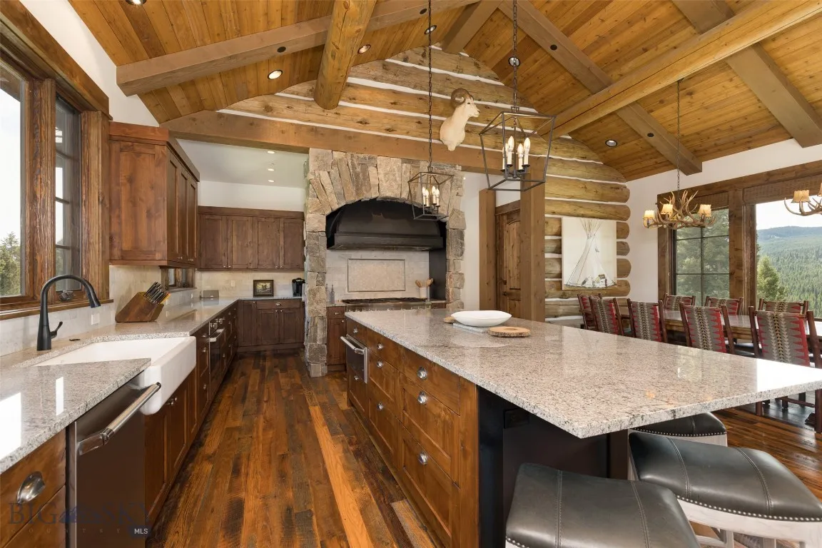 Gourmet kitchen featuring rich wood cabinetry, high-end stainless steel appliances