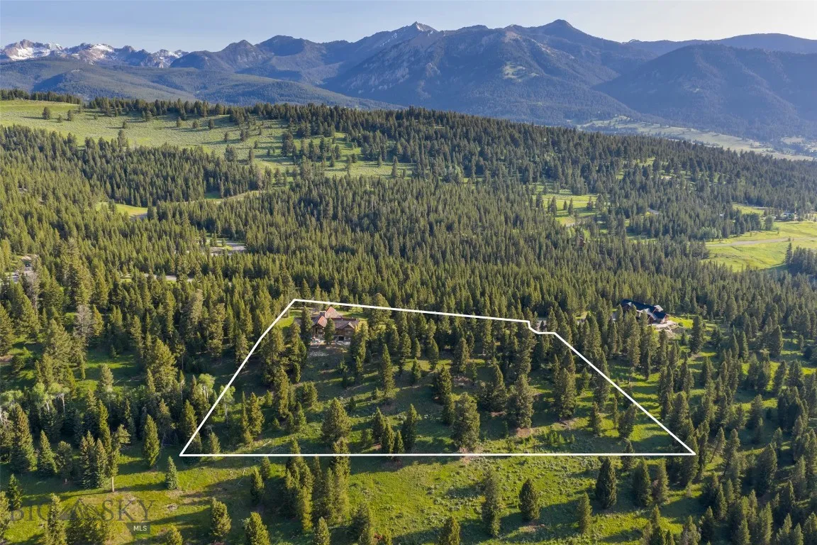 Aerial views showcase this exceptional mountain estate tucked into a private forested setting, with breathtaking scenery, winding roads, and stunning alpine surroundings—just minutes from world-class amenities.