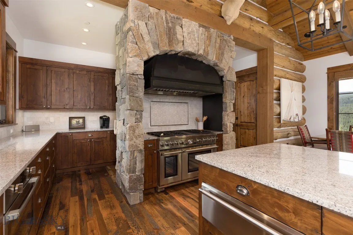 Warm hardwood floors, and stone accents create a perfect blend of rustic charm and modern luxury