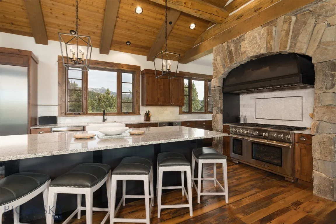 Warm hardwood floors, and stone accents create a perfect blend of rustic charm and modern luxury