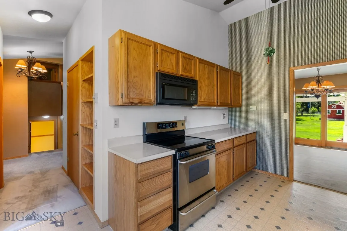 kitchen to hallway to Entry, coat closet, & pantry.