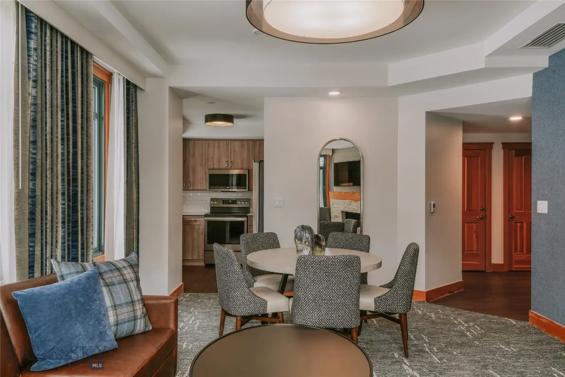 Open-concept living and dining space with fireplace and seating.