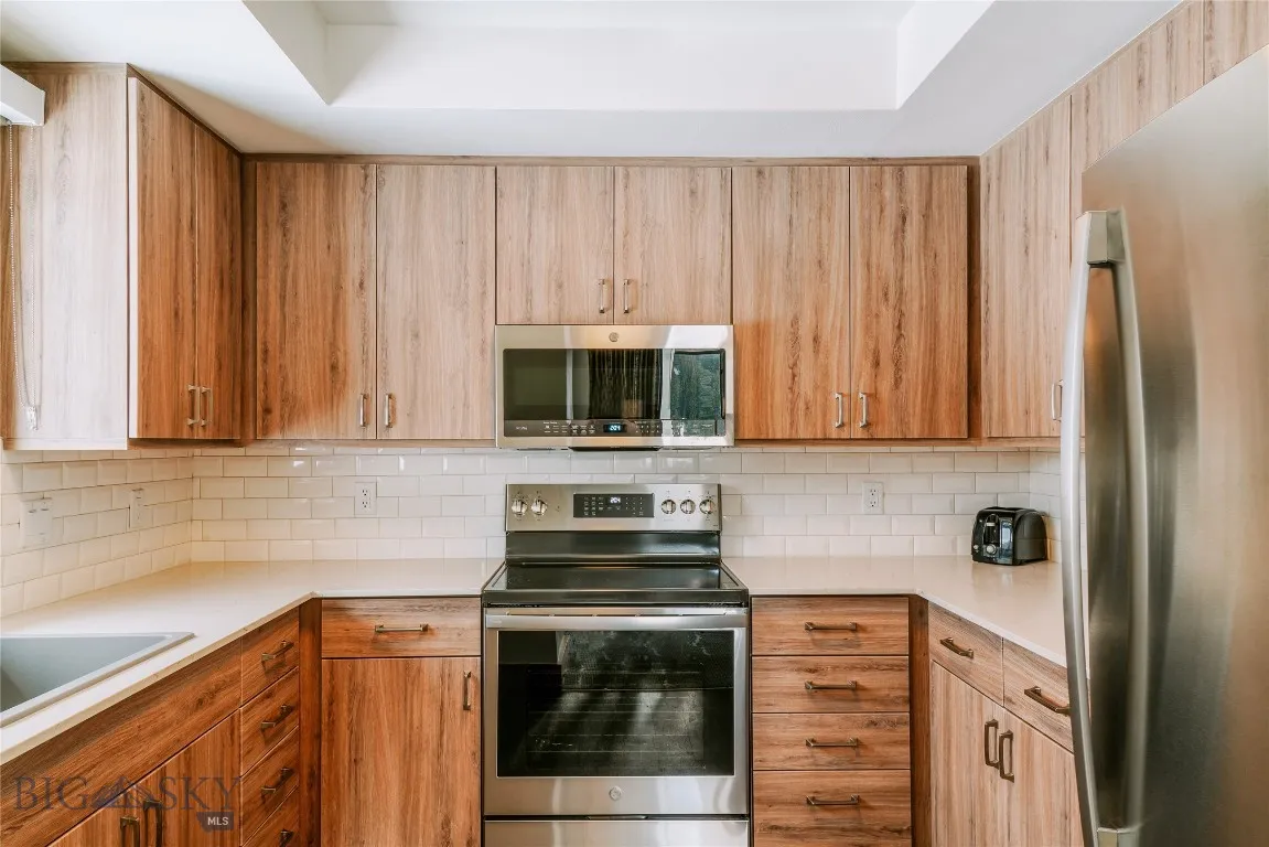 Modern kitchen with stainless steel appliances and sleek cabinetry.