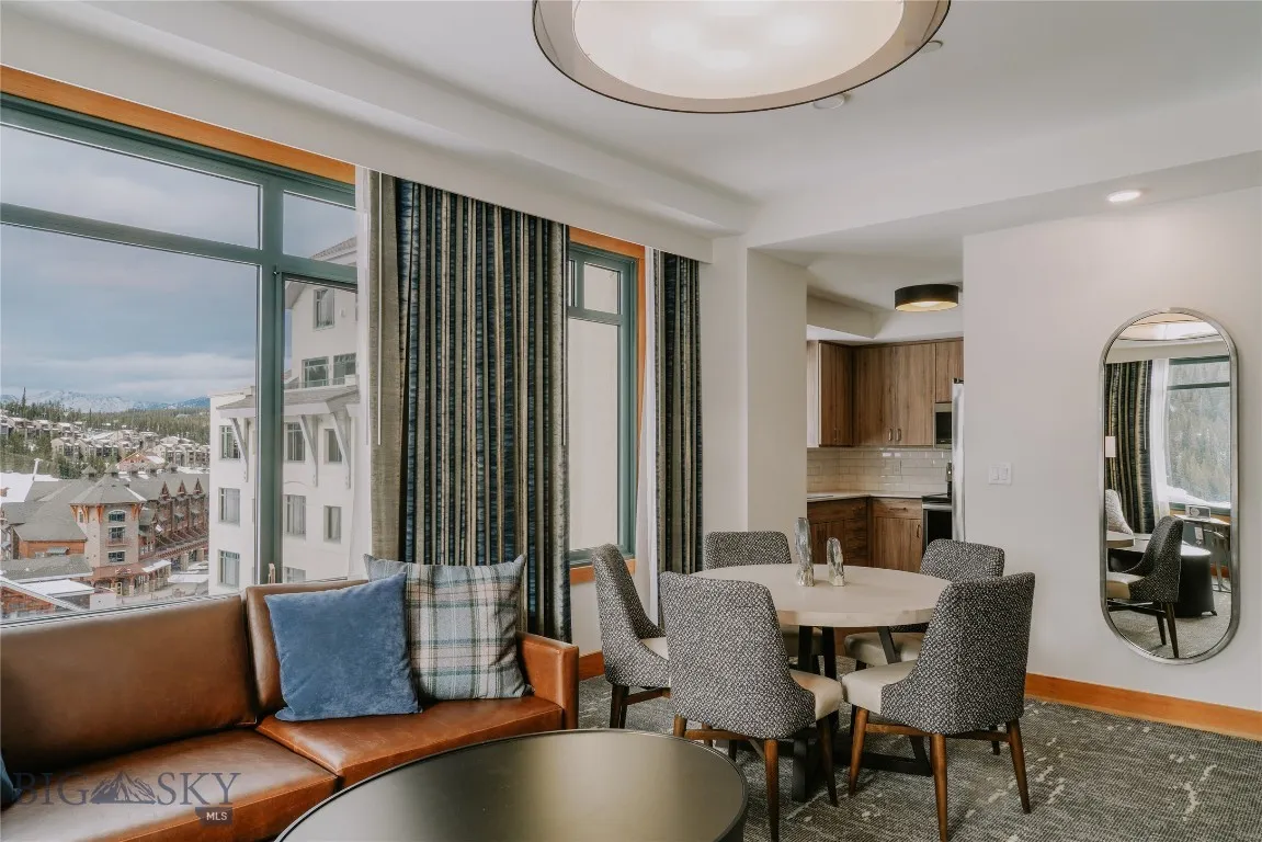 Open-concept living and dining space with fireplace and seating.