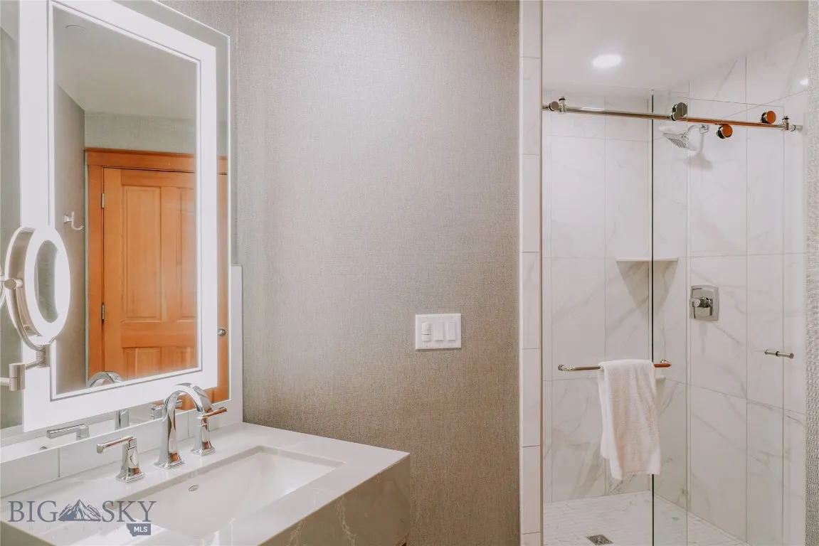 Contemporary bathroom with walk-in shower and modern finishes.