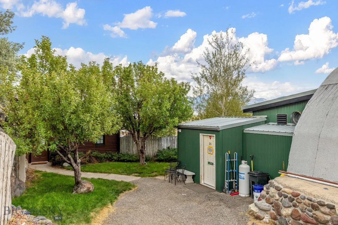 Asphalt driveway to the shop entry and walkway to front of the house