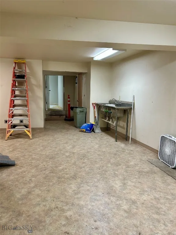 Basement storage or prep area with sink
