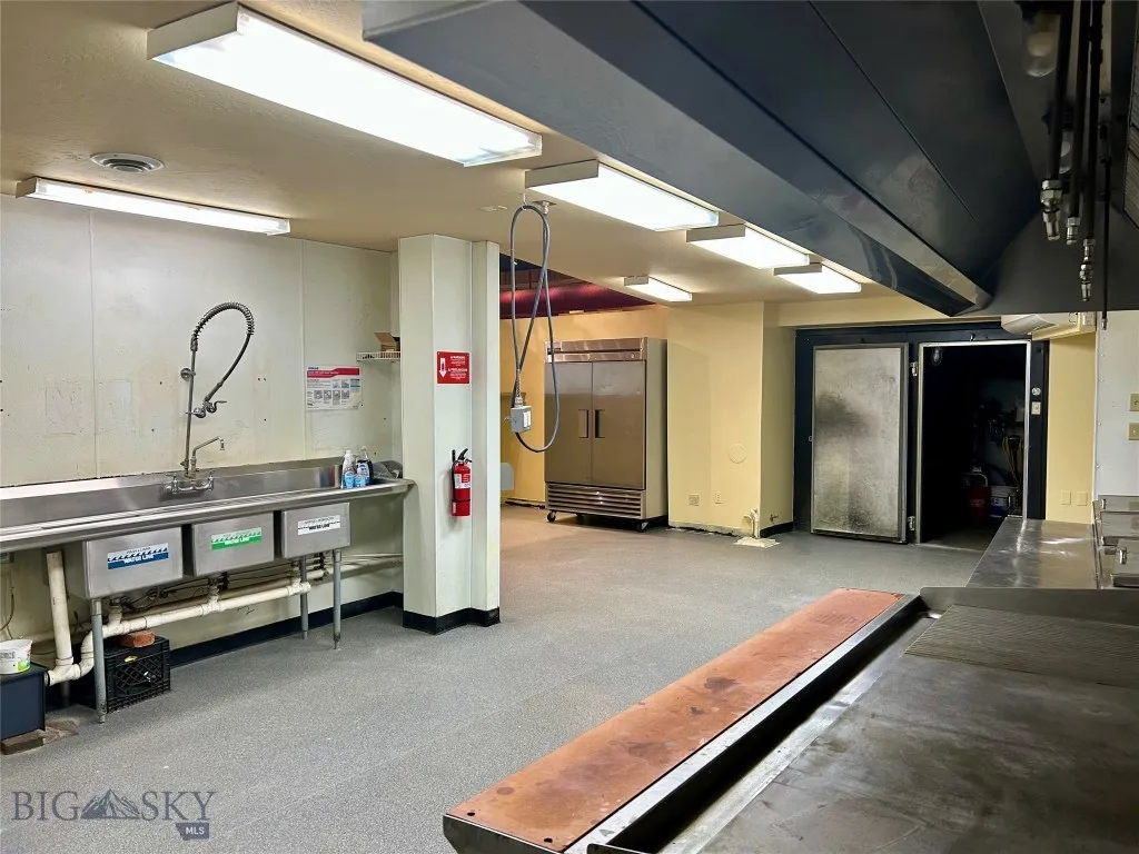 Kitchen with sinks on left and walk-in at back