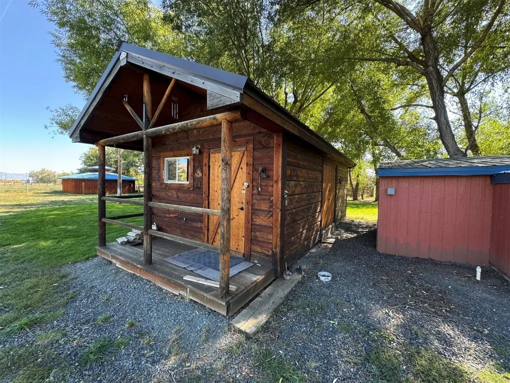 Log shed with wood stove inside