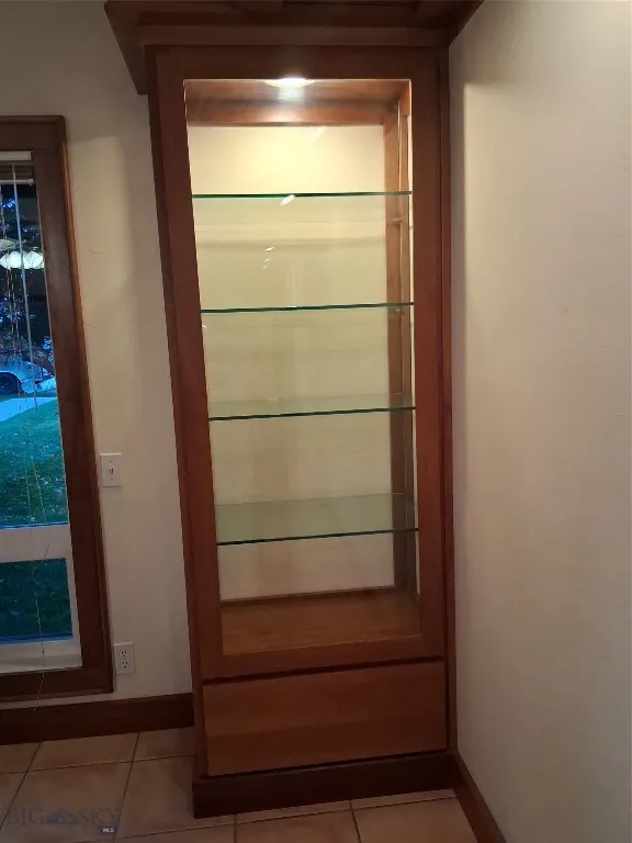 1 of 2 built-in solid cherry lighted cabinets in living room