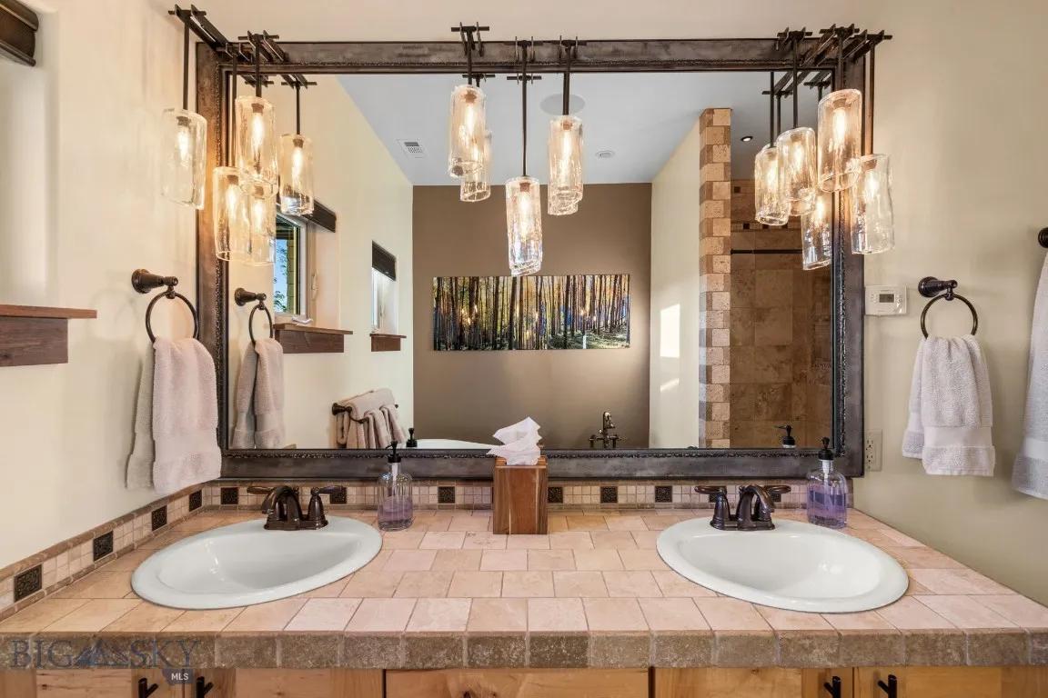 One of a kind artisan vanity by Ironglass Lighting in primary bath