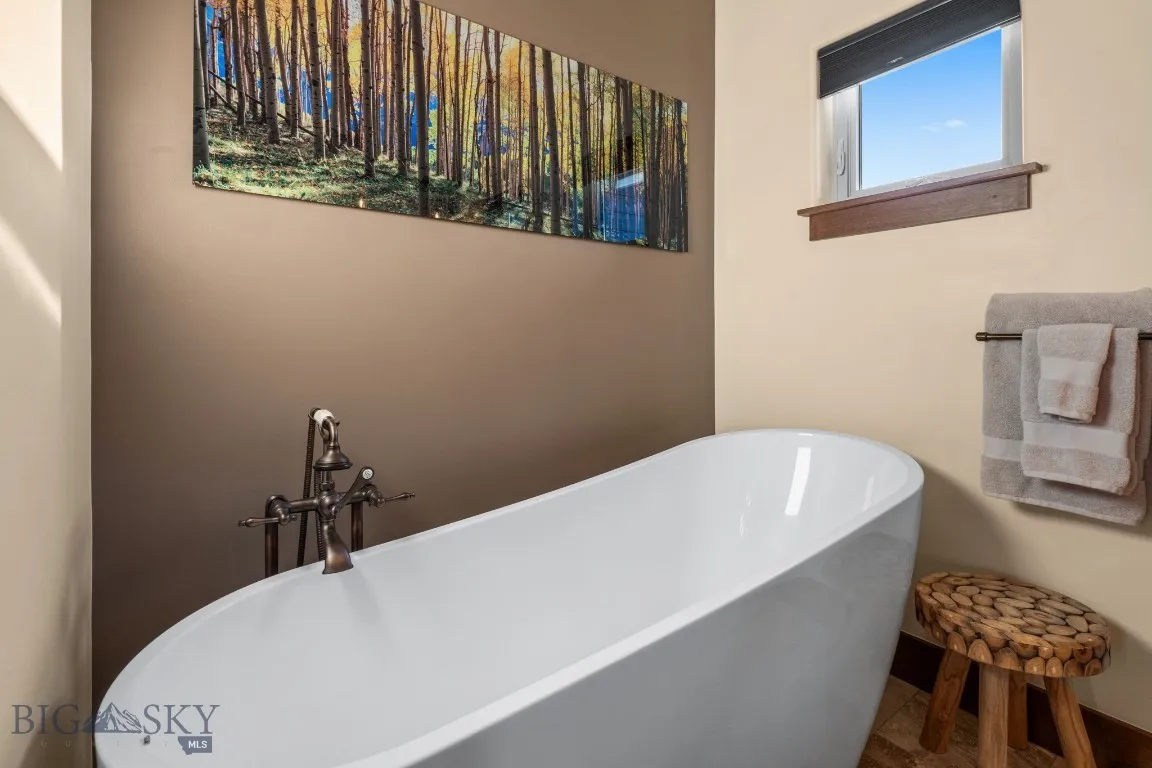 Luxurious soaking tub with shower handle in primary bath