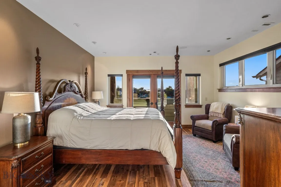 Primary suite featuring multiple windows, french doors, ample space and views
