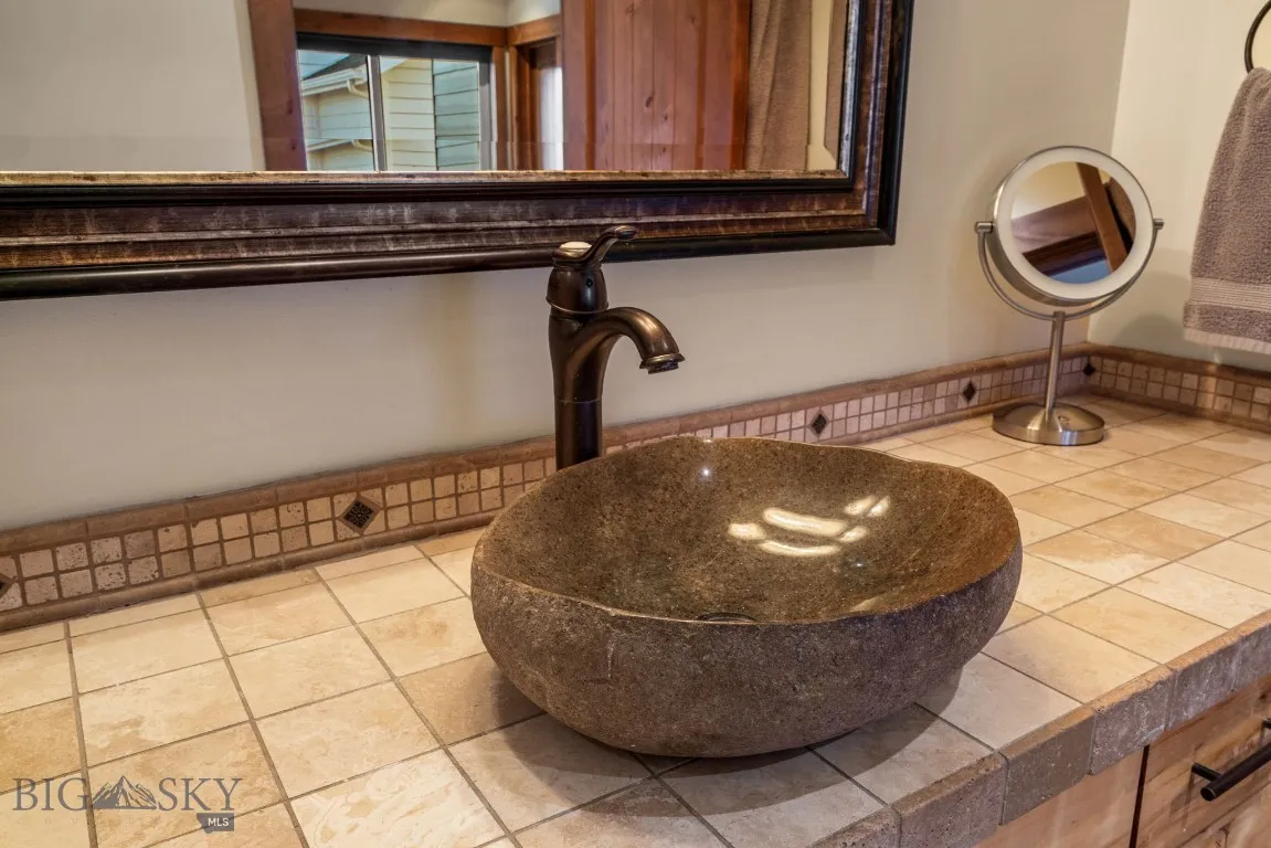 Guest bath stone vessel sink and Montana Travertine tile
