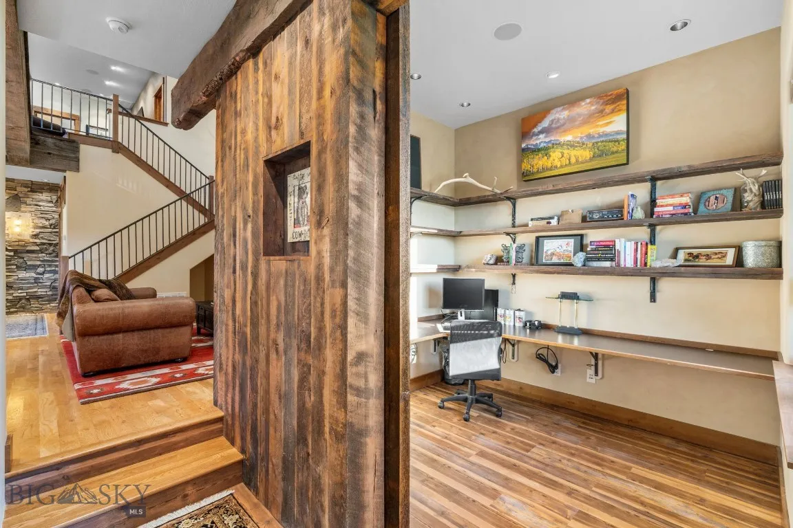 Office with huge rustic timber sliding door for privacy, heated floors, reclaimed lumber shelves and spacious desktop