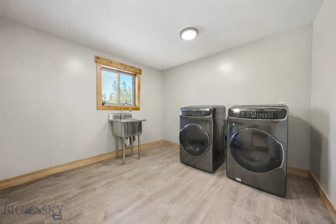 Laundry room. Attached to both primary bathroom and hallway.
